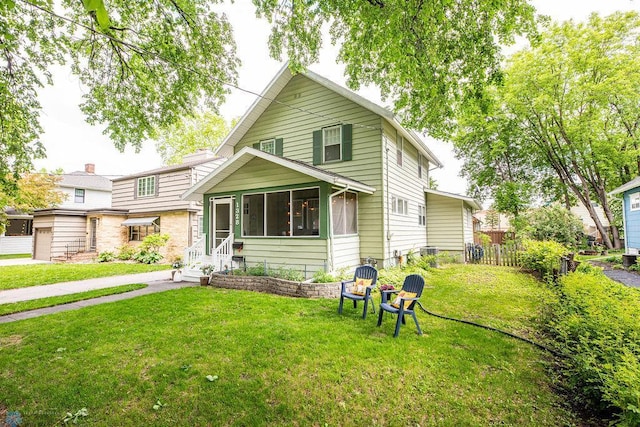 1328 6th St S, Fargo, ND 58103 - view of front of house with a sunroom and entry steps