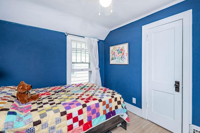 1328 6th St S, Fargo, ND 58103 - bedroom featuring wood finished floors, a ceiling fan, lofted ceiling, and baseboards