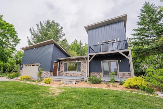 E13680 Stelter Rd, Fall Creek, WI 54742 - view of front of home featuring a balcony, a front lawn, stone siding, and board and batten siding
