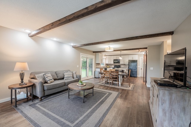 E13680 Stelter Rd, Fall Creek, WI 54742 - living area with beamed ceiling, wood finished floors, and baseboards
