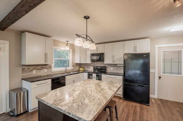 E13680 Stelter Rd, Fall Creek, WI 54742 - kitchen featuring black appliances, a sink, dark wood-type flooring, tasteful backsplash, and white cabinets