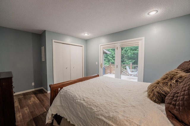 E13680 Stelter Rd, Fall Creek, WI 54742 - bedroom featuring access to outside, dark wood-style flooring, a textured ceiling, baseboards, and a closet