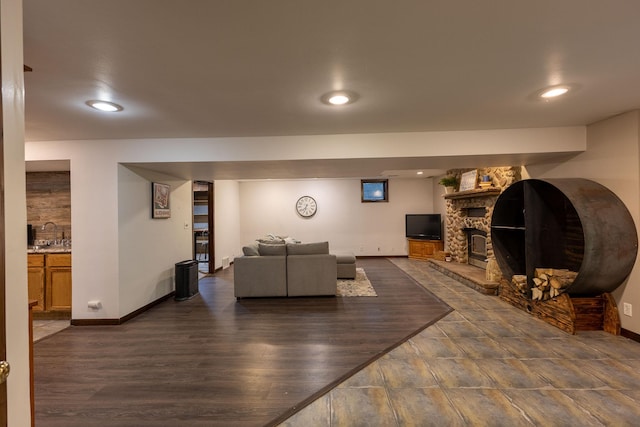 E13680 Stelter Rd, Fall Creek, WI 54742 - living room featuring a stone fireplace, baseboards, recessed lighting, and wood finished floors