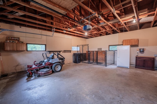 E13680 Stelter Rd, Fall Creek, WI 54742 - garage featuring freestanding refrigerator and a garage door opener