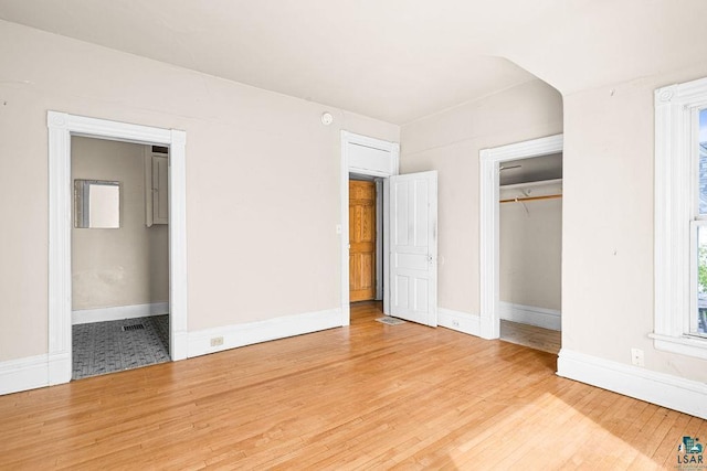 220 12th Ave E, Duluth, MN 55805 - unfurnished bedroom featuring light wood-type flooring, baseboards, and a closet