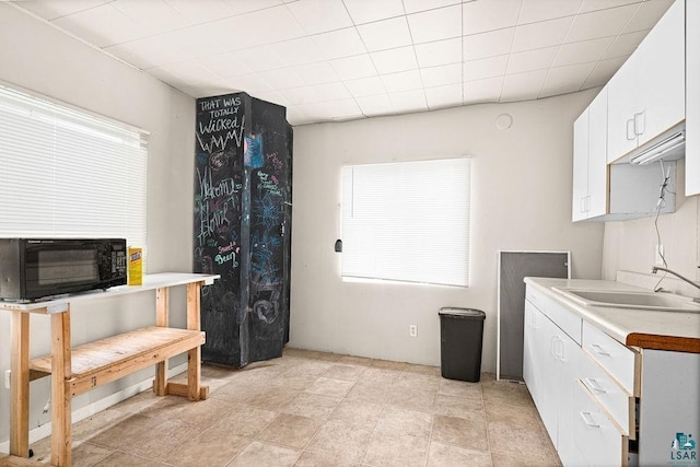 220 12th Ave E, Duluth, MN 55805 - kitchen with a sink, white cabinets, and light countertops