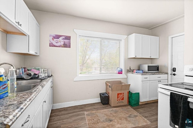 220 12th Ave E, Duluth, MN 55805 - kitchen featuring white appliances, dark wood-style flooring, white cabinetry, baseboards, and light countertops