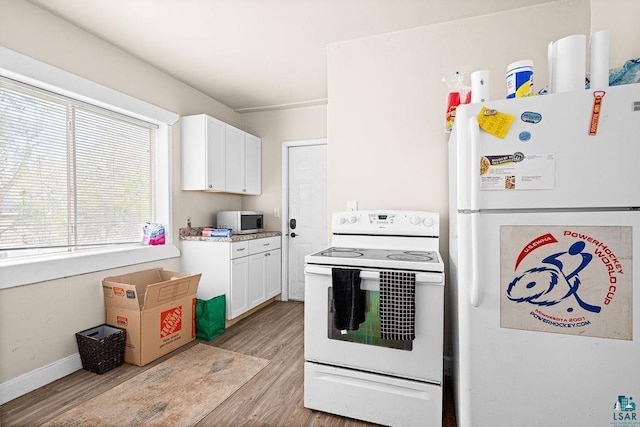 220 12th Ave E, Duluth, MN 55805 - kitchen with white appliances, light wood-type flooring, white cabinetry, and light countertops
