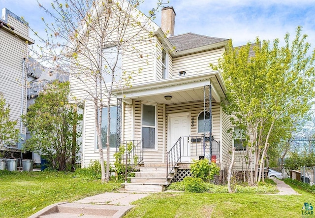 220 12th Ave E, Duluth, MN 55805 - view of front of house featuring a front yard and a chimney