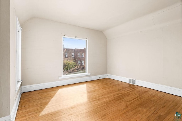 220 12th Ave E, Duluth, MN 55805 - additional living space with wood-type flooring, vaulted ceiling, and baseboards