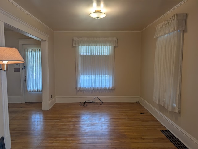 1713 Penn Ave N, Minneapolis, MN 55411 - unfurnished room featuring wood finished floors, ornamental molding, and baseboards