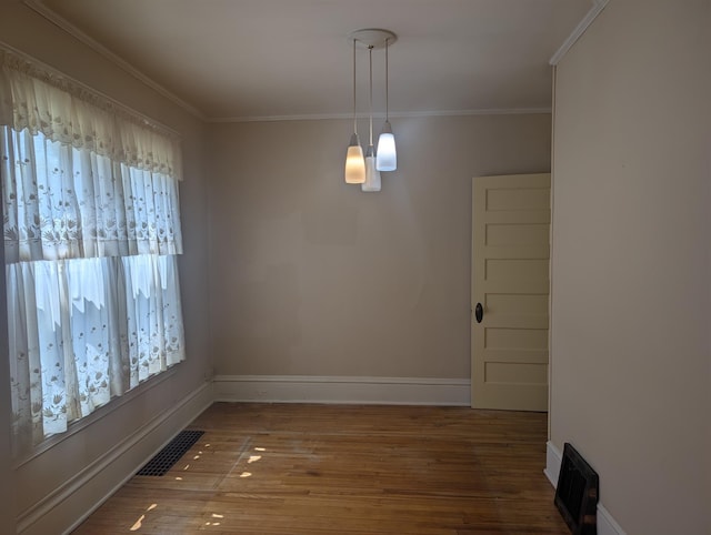 1713 Penn Ave N, Minneapolis, MN 55411 - unfurnished dining area with wood finished floors, ornamental molding, and baseboards