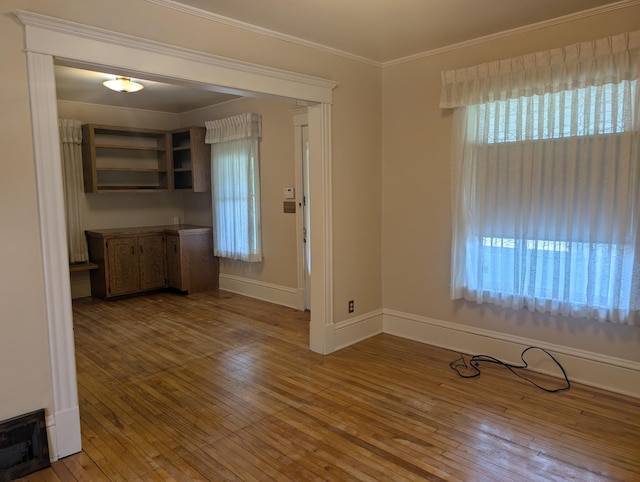 1713 Penn Ave N, Minneapolis, MN 55411 - unfurnished dining area featuring wood-type flooring, plenty of natural light, and ornamental molding