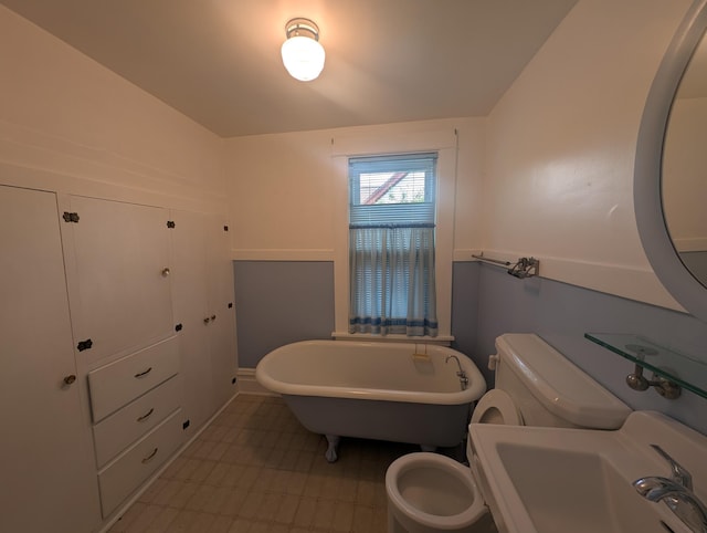 1713 Penn Ave N, Minneapolis, MN 55411 - bathroom featuring a freestanding bath, toilet, a sink, and baseboards