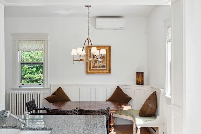 226 Grotto St S, Saint Paul, MN 55105 - detailed view of radiator, a wall mounted AC, a sink, a chandelier, and a wainscoted wall