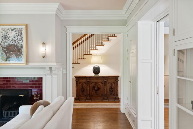 226 Grotto St S, Saint Paul, MN 55105 - stairway with wood finished floors, ornamental molding, and a brick fireplace
