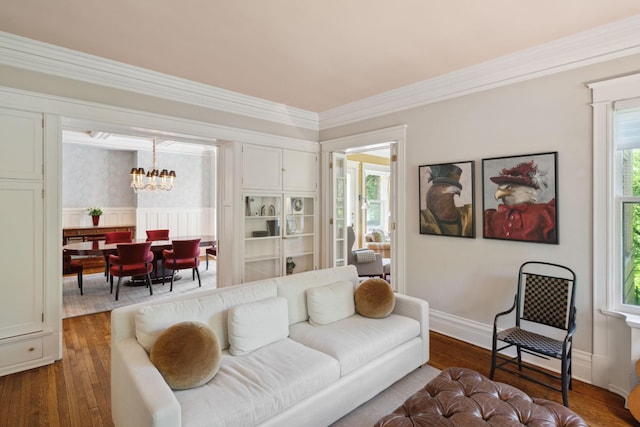 226 Grotto St S, Saint Paul, MN 55105 - living room featuring a chandelier, wainscoting, dark wood-style floors, and ornamental molding
