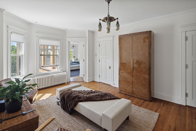 226 Grotto St S, Saint Paul, MN 55105 - bedroom with a chandelier, radiator, crown molding, wood finished floors, and baseboards