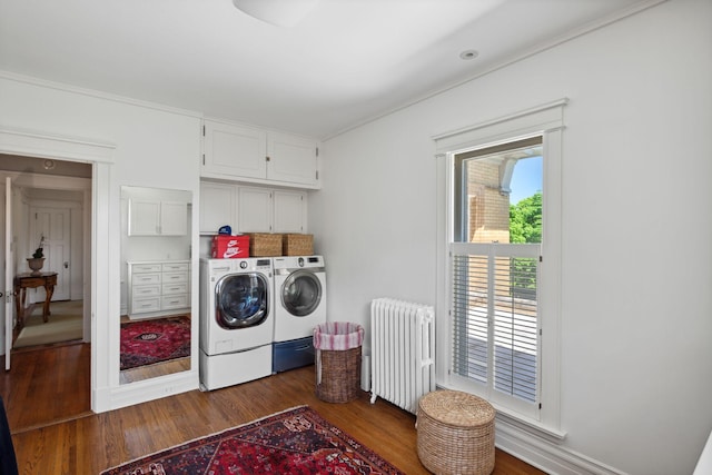 226 Grotto St S, Saint Paul, MN 55105 - laundry area featuring radiator heating unit, cabinet space, washing machine and dryer, dark wood-style floors, and crown molding