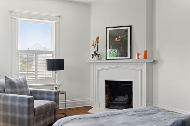 226 Grotto St S, Saint Paul, MN 55105 - bedroom featuring wood finished floors, baseboards, and a fireplace with flush hearth
