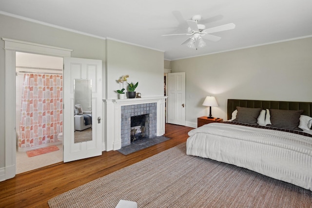 226 Grotto St S, Saint Paul, MN 55105 - bedroom featuring wood finished floors, ornamental molding, baseboards, a tile fireplace, and ensuite bathroom