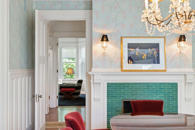 226 Grotto St S, Saint Paul, MN 55105 - living area featuring wallpapered walls, a chandelier, and a tile fireplace