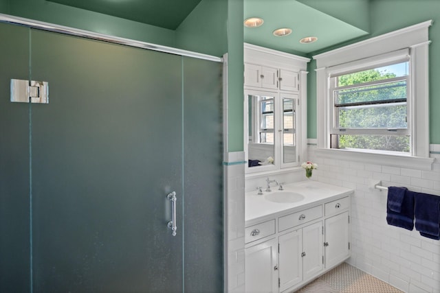 226 Grotto St S, Saint Paul, MN 55105 - bathroom featuring tile walls, vanity, a stall shower, a wainscoted wall, and tile patterned floors