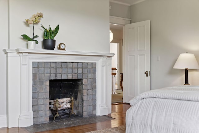 226 Grotto St S, Saint Paul, MN 55105 - bedroom featuring wood finished floors, a fireplace, and crown molding