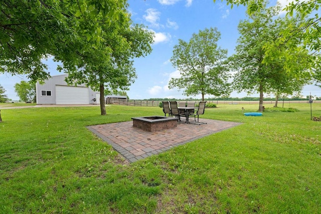 21750 County 36, Reynolds Twp, MN 56347 - view of yard featuring an outdoor fire pit, a patio, an outdoor structure, and a garage