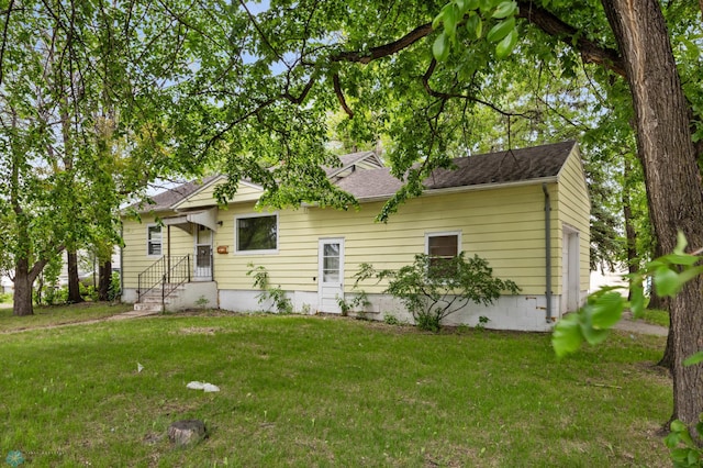 1550 13 1/2 St S, Fargo, ND 58103 - rear view of house with a yard and roof with shingles