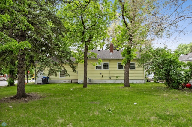 1550 13 1/2 St S, Fargo, ND 58103 - back of property with a chimney and a lawn