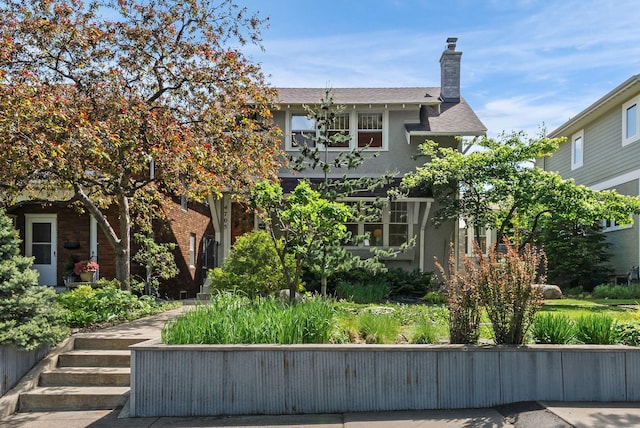 4705 Lyndale Ave S, Minneapolis, MN 55419 - view of front facade with stucco siding, a shingled roof, and a chimney
