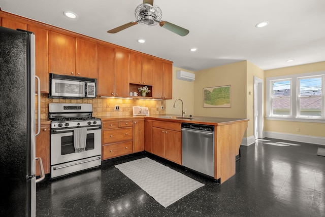 4705 Lyndale Ave S, Minneapolis, MN 55419 - kitchen featuring appliances with stainless steel finishes, a sink, a peninsula, tasteful backsplash, and ceiling fan