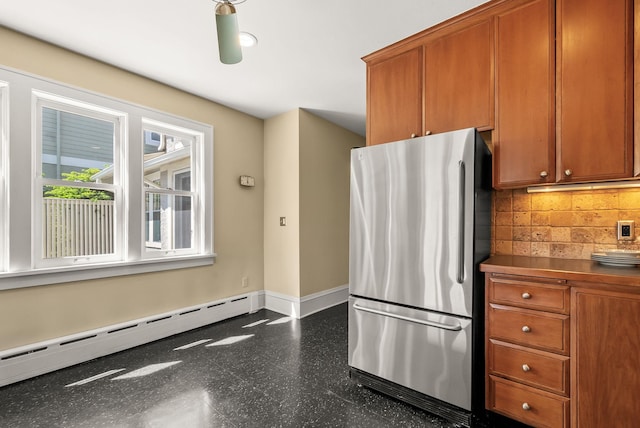 4705 Lyndale Ave S, Minneapolis, MN 55419 - kitchen with freestanding refrigerator, a baseboard heating unit, baseboards, and brown cabinetry