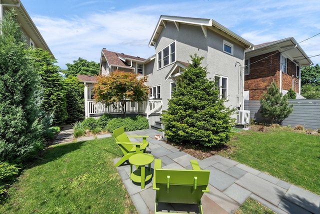 4705 Lyndale Ave S, Minneapolis, MN 55419 - back of house with a yard, a cooling unit, brick siding, and a wooden deck