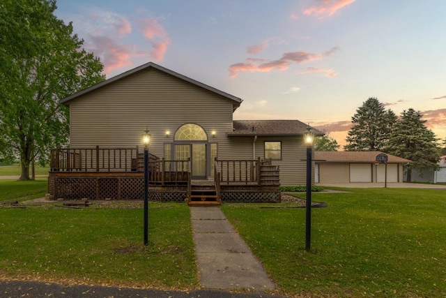 425 Franklin St, Morristown, MN 55052 - view of front facade featuring a deck, a yard, and a garage