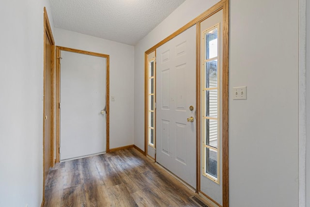 425 Franklin St, Morristown, MN 55052 - entrance foyer featuring wood finished floors, a textured ceiling, and baseboards