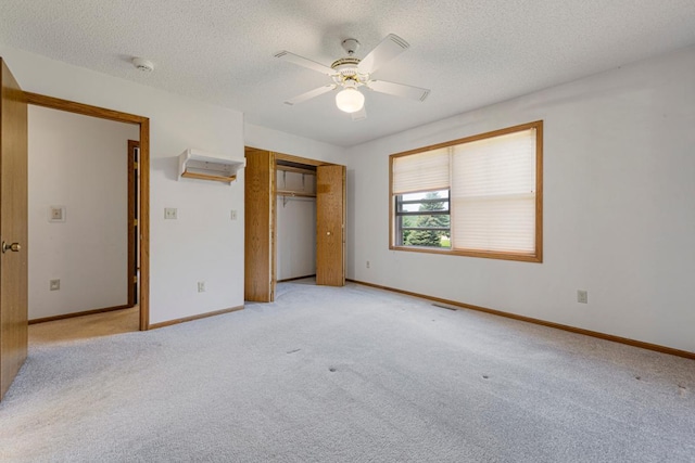425 Franklin St, Morristown, MN 55052 - unfurnished bedroom featuring light colored carpet, a textured ceiling, a closet, a ceiling fan, and baseboards