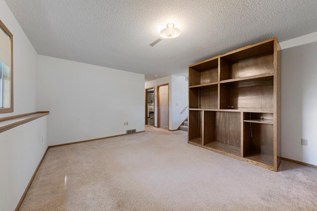 425 Franklin St, Morristown, MN 55052 - empty room featuring light colored carpet, a textured ceiling, stairway, and baseboards