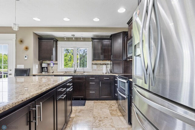 18117 Cherry Creek Ln, Erie Twp, MN 56501 - kitchen featuring stainless steel appliances, backsplash, a sink, light stone countertops, and recessed lighting
