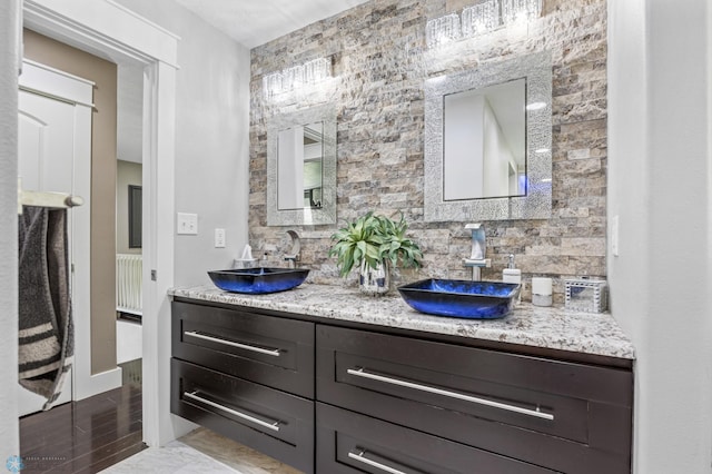 18117 Cherry Creek Ln, Erie Twp, MN 56501 - bathroom featuring double vanity and backsplash