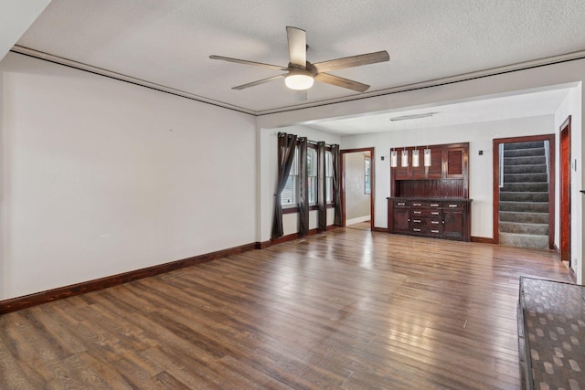 1148 Geranium Ave E, Saint Paul, MN 55106 - unfurnished living room featuring a ceiling fan, stairway, wood finished floors, baseboards, and a textured ceiling