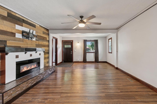 1148 Geranium Ave E, Saint Paul, MN 55106 - unfurnished living room featuring wood finished floors, ceiling fan, baseboards, a large fireplace, and wood walls