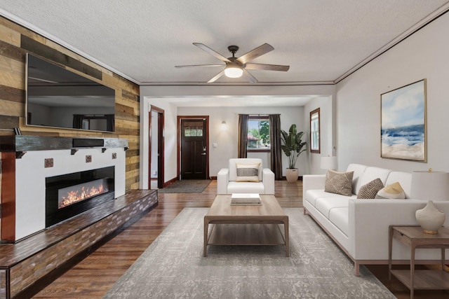 1148 Geranium Ave E, Saint Paul, MN 55106 - living room featuring wood finished floors, a ceiling fan, a large fireplace, wooden walls, and baseboards