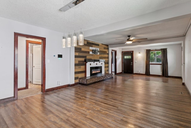 1148 Geranium Ave E, Saint Paul, MN 55106 - unfurnished living room with wood finished floors, ceiling fan, baseboards, a textured ceiling, and a fireplace