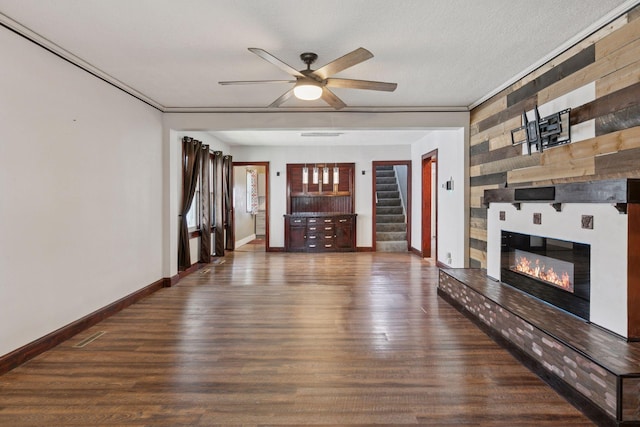 1148 Geranium Ave E, Saint Paul, MN 55106 - unfurnished living room with a large fireplace, a ceiling fan, wood finished floors, and stairway