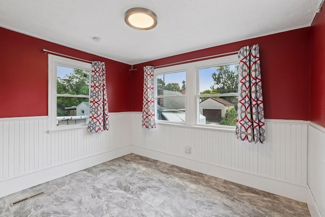 1148 Geranium Ave E, Saint Paul, MN 55106 - empty room with wainscoting and healthy amount of natural light