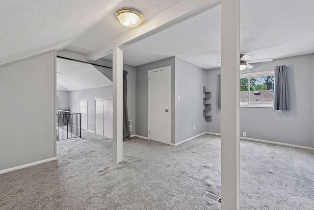 1148 Geranium Ave E, Saint Paul, MN 55106 - unfurnished living room featuring carpet floors, a textured ceiling, baseboards, vaulted ceiling, and a ceiling fan
