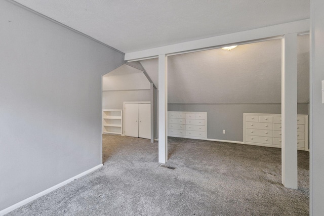 1148 Geranium Ave E, Saint Paul, MN 55106 - unfurnished bedroom with carpet floors, lofted ceiling, two closets, and baseboards