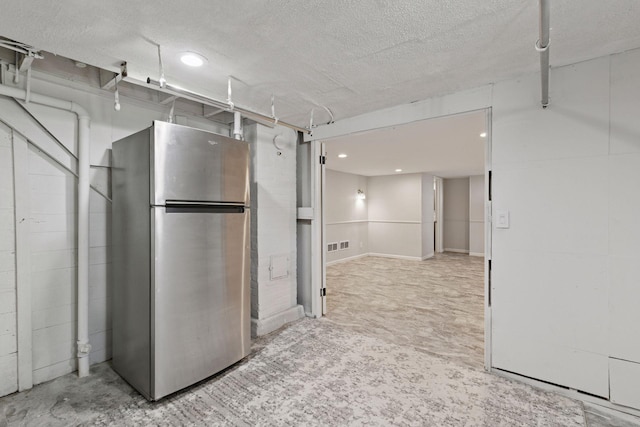 1148 Geranium Ave E, Saint Paul, MN 55106 - below grade area with freestanding refrigerator, a textured ceiling, and recessed lighting